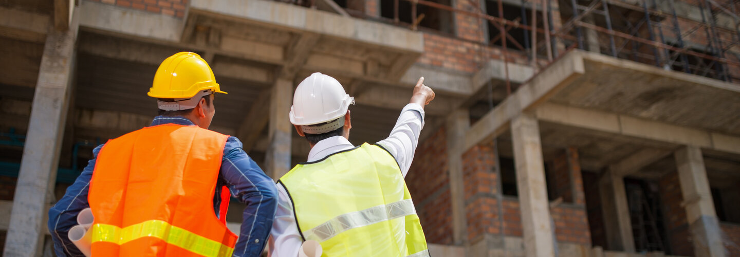 construction works on site wearing hard hats. 