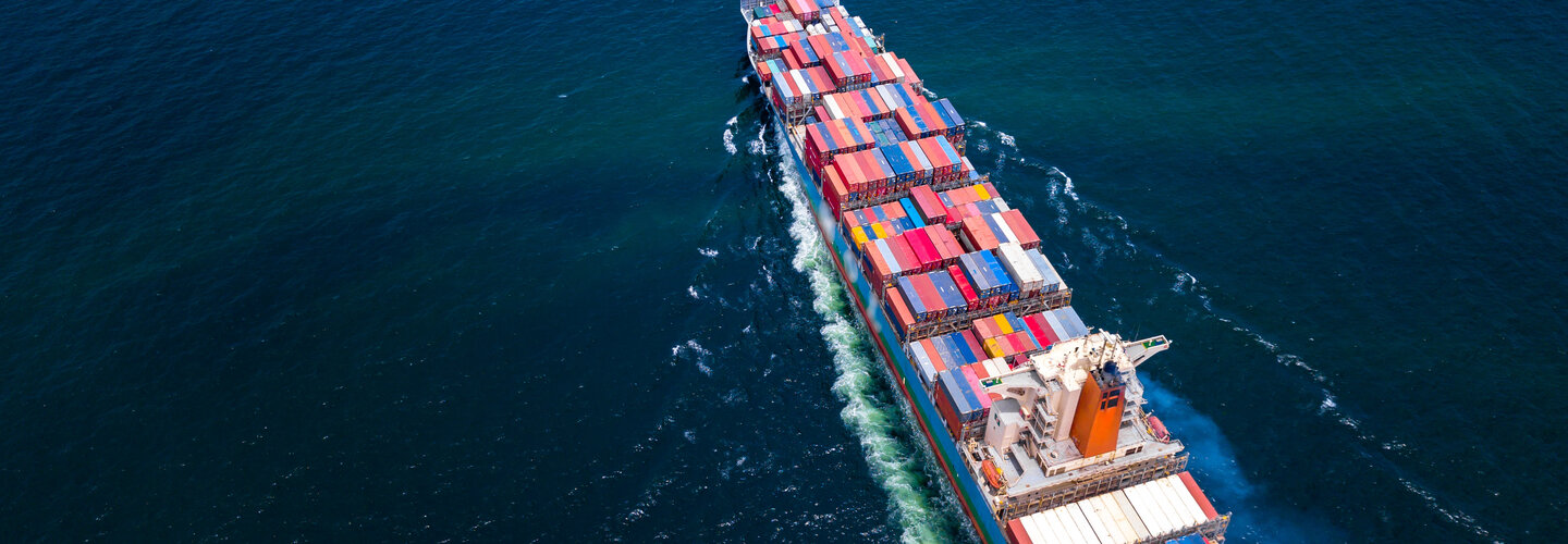 Maritime ship carrying cargo crosses the ocean.