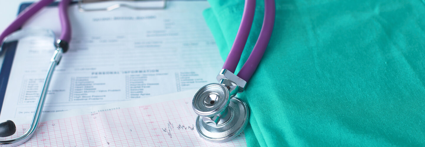 Stethoscope resting on teal scrubs