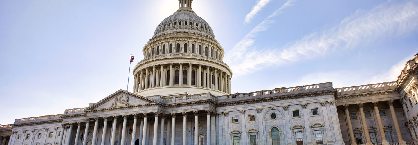 sideway angle shot of the capitol building in washington d.c. during a bright cloudless day.
