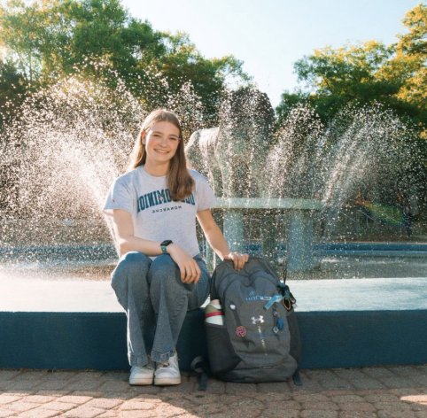 Student sitting at fountain