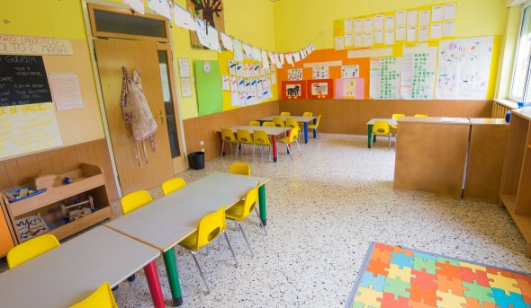 Kindergarten classroom with tables and chairs.