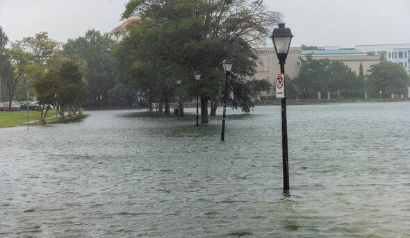 Street lights are surrounded by flood waters. 