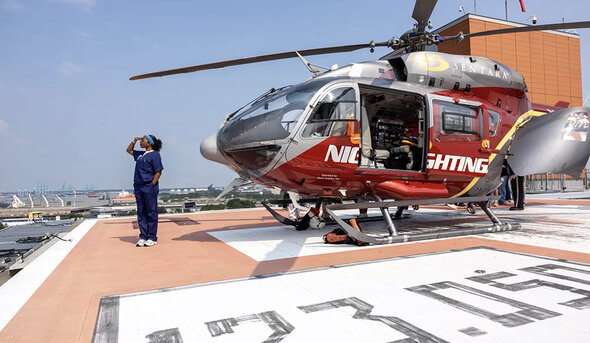 A student on helipad with Nightingale emergency helicopter.