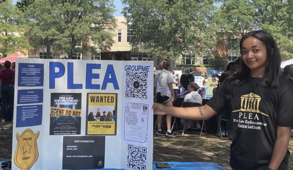 women stands next to placard outside