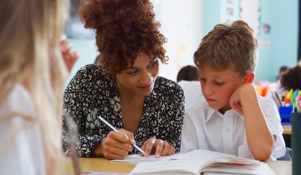 Teacher helping a child in class