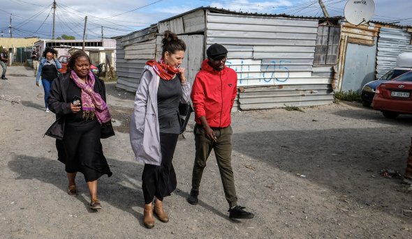 Melissa Miller-Felton,  Jennifer Fish, Ph.D., and  Khayalethu Kama walk the streets of Khayelitsha, South Africa.
