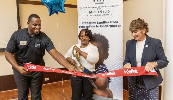 People cutting a ribbon at a ribbon-cutting event