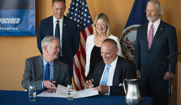MOU signing with five people around table