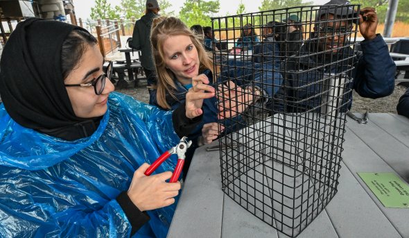 Two women work on oyster cage