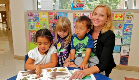 A photo of a teacher with a group of kids.