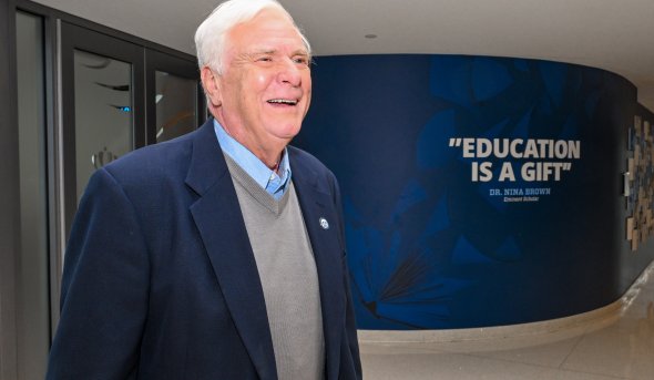 ODU alumnus Don Musacchio stands in the hallway in the Education Building 