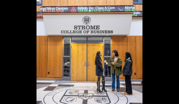 Business students stand in the atrium of Constant Hall.