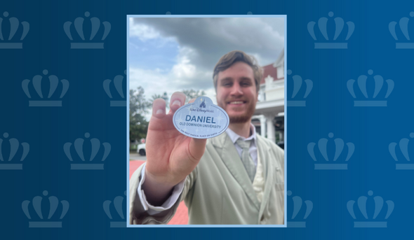 Daniel Ross holding a badge with his name and "Old Dominion University" 