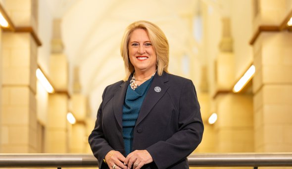 ODU alumna Janet Carter inside a bright hallway.