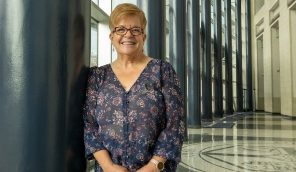 ODU alumna Michele Mulich inside the large lobby at Chartway. 