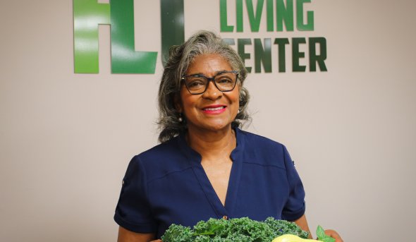Olivia Newby in front of healthy living center sign