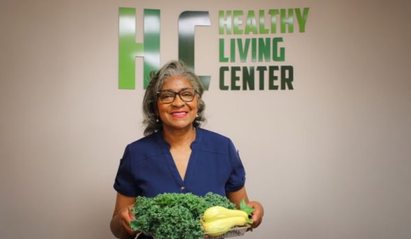 Olivia Newby in front of healthy living center sign