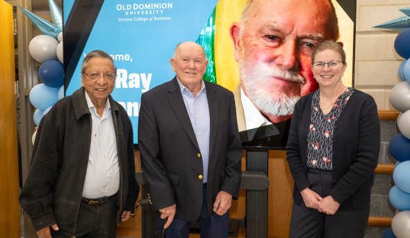 Vinod Argarwal, Ray Strangways and Erika Marsillac stand in front to a post of Ray.