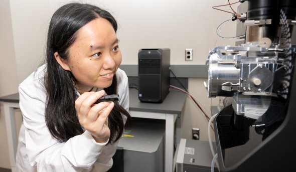 A photo of Yuting Zhu holding a flashlight.
