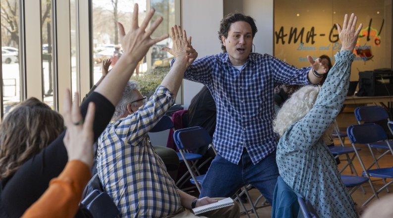 Group of people with arms raised