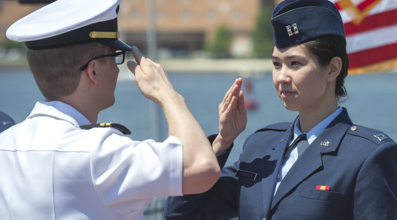 Military members salute each other
