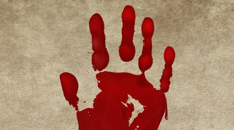 bloody handprint on a piece of parchment
