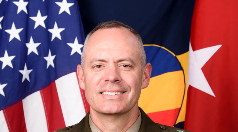 U.S. Army Major Gen. John Kline standing in uniform in front of an american flag