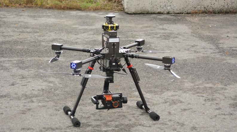a drone is resting on a concrete slab waiting to take flight 