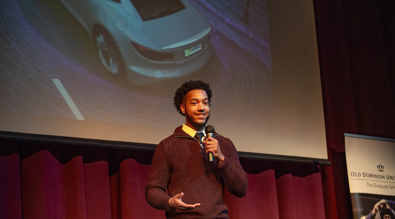 Student speaks on a stage