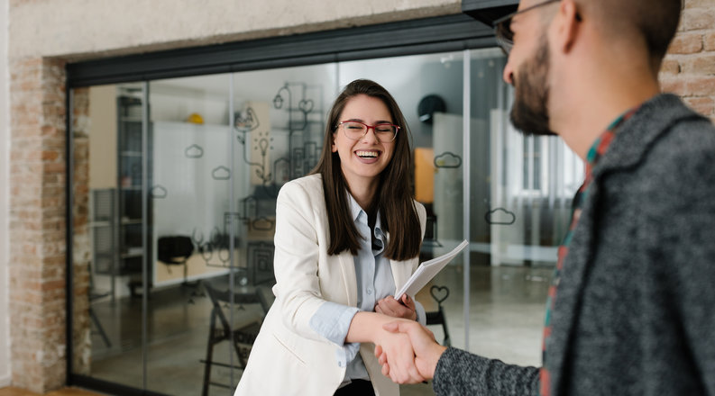 Woman and man shaking hands