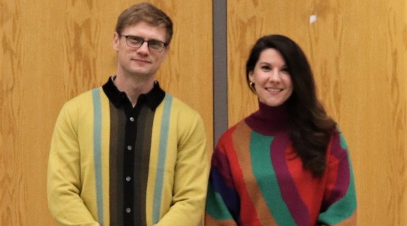 Two people standing in a room