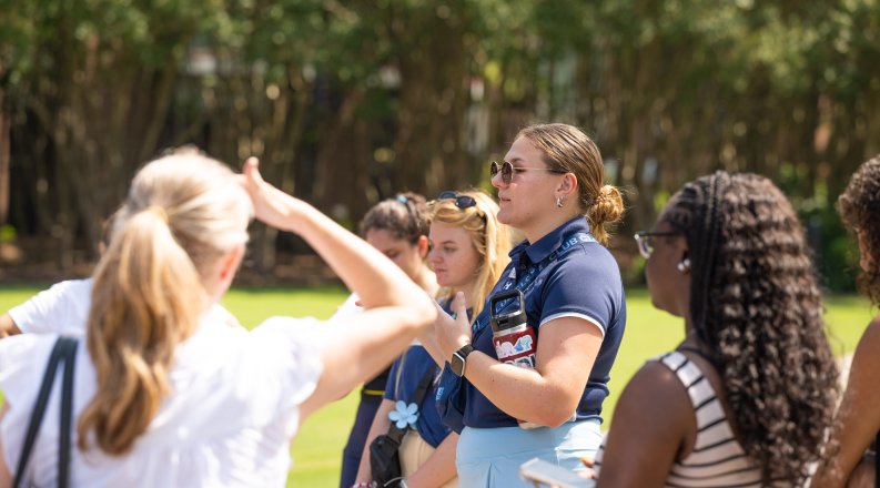 Woman talks to students