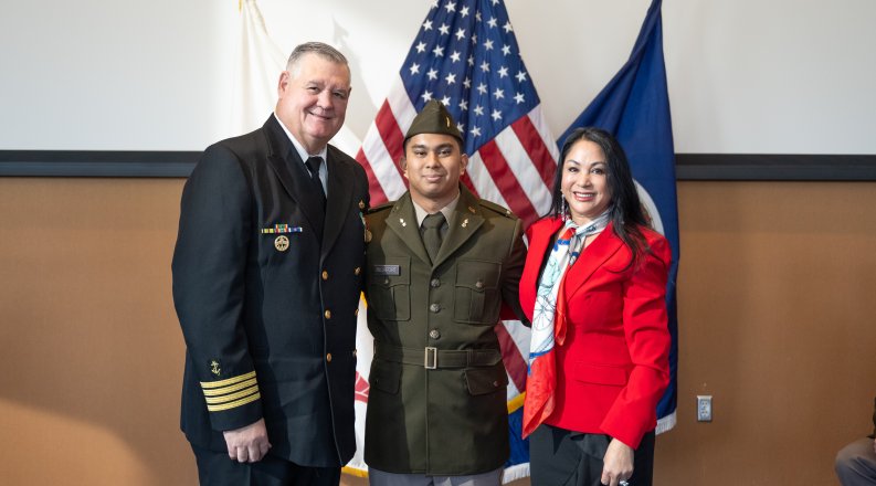An Army ROTC student poses with his family.