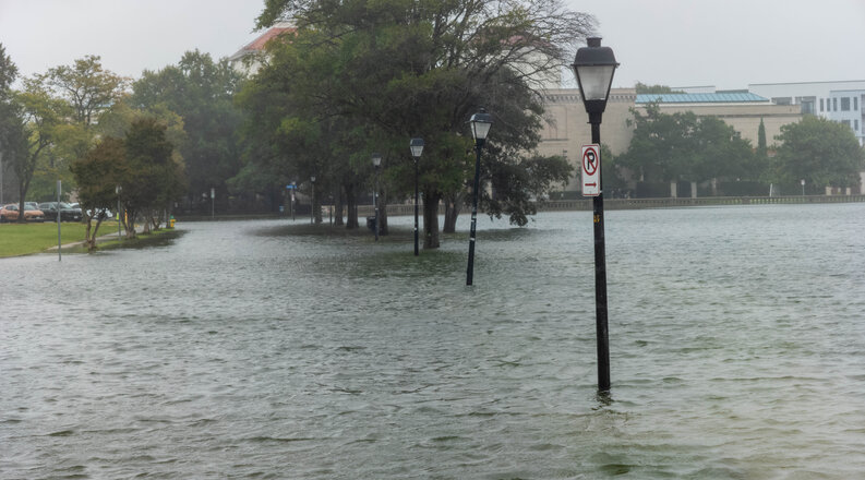 Street lights are surrounded by flood waters. 