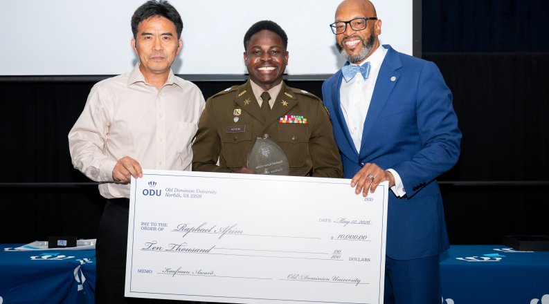 Jiang Li, Raphael Kesse Afrim and ODU President Brian O. Hemphill stand together with a big check