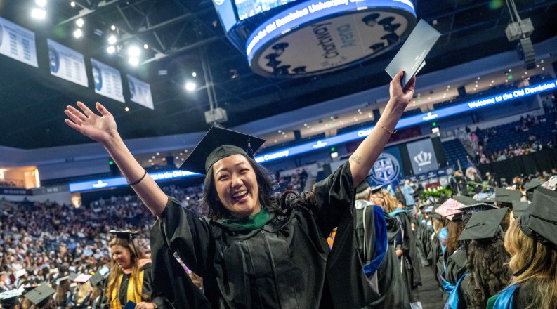 A student celebrates at commencement.