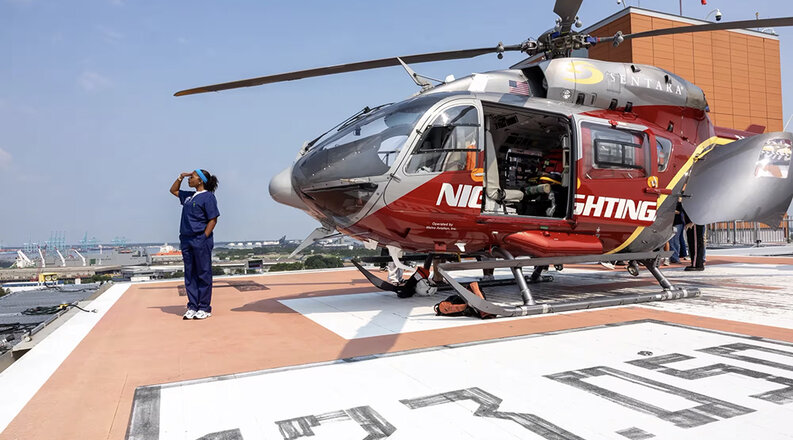A student on helipad with Nightingale emergency helicopter.