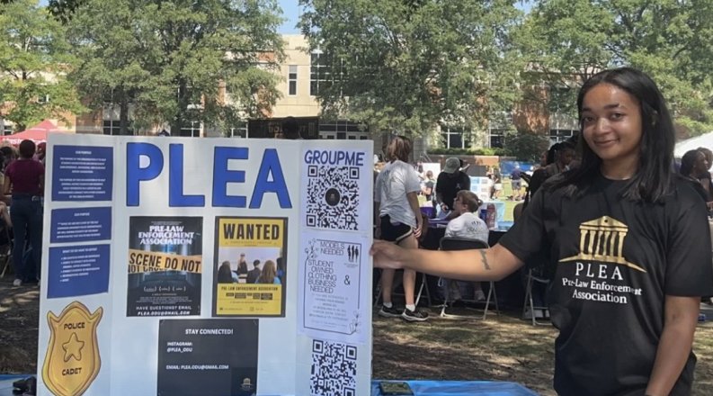 women stands next to placard outside