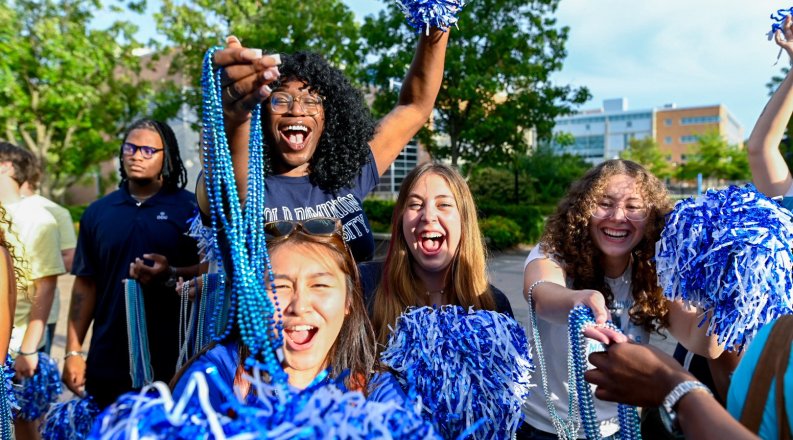 Students waving streamers and pom poms.