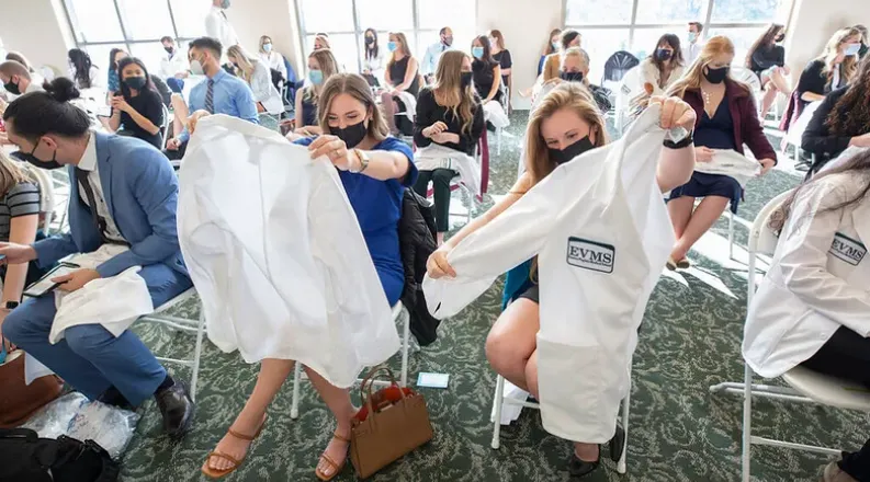 Members of the PA White Coat Class of 2024 hold up their jac
