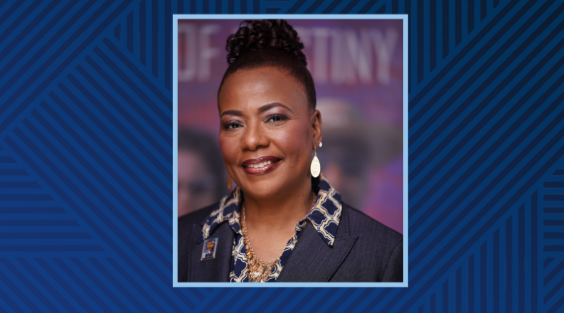 A Black woman poses in front of a purple background.
