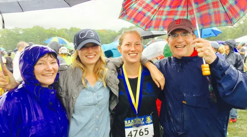 Runner with three family members in the rain