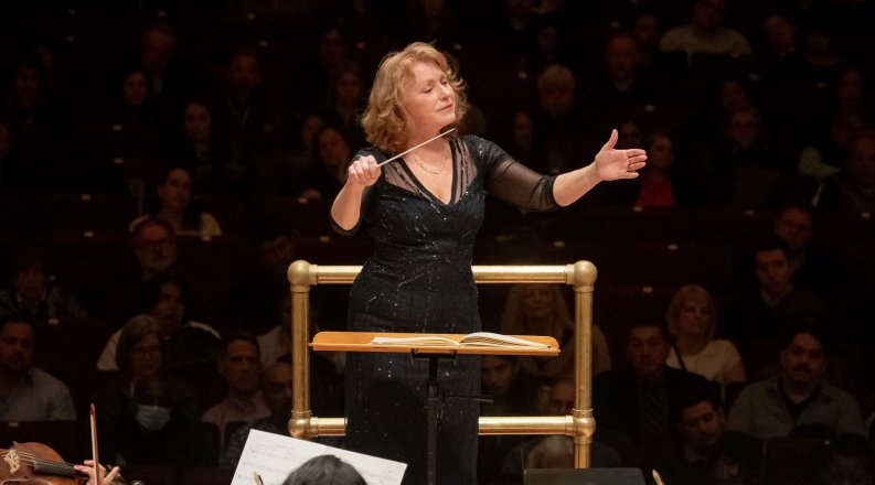 A woman conducting at Carnegie Hall.