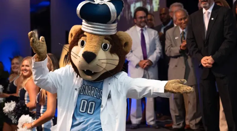 ODU Monarch wearing a white coat