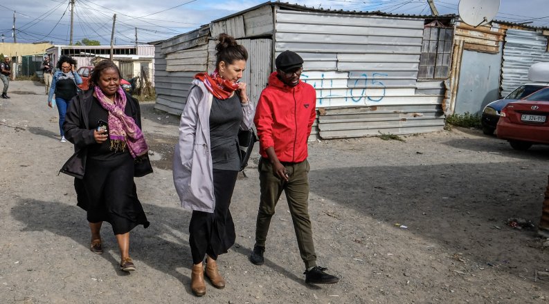 Melissa Miller-Felton,  Jennifer Fish, Ph.D., and  Khayalethu Kama walk the streets of Khayelitsha, South Africa.