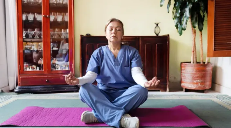 Woman in scrubs meditating