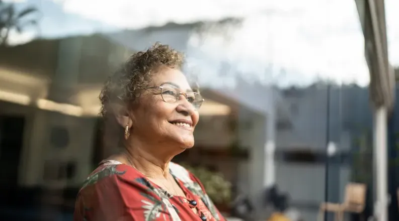 Woman looking out the window and smiling