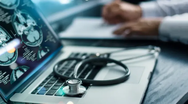 laptop with stethescope on top