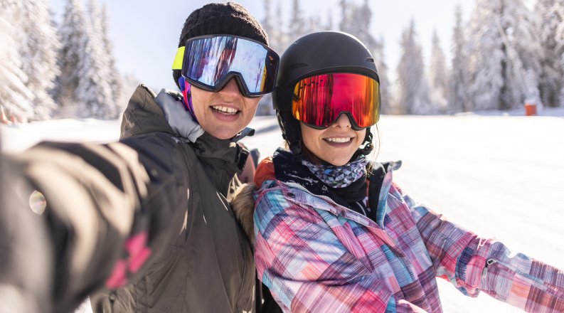 Snowboarders wearing goggle